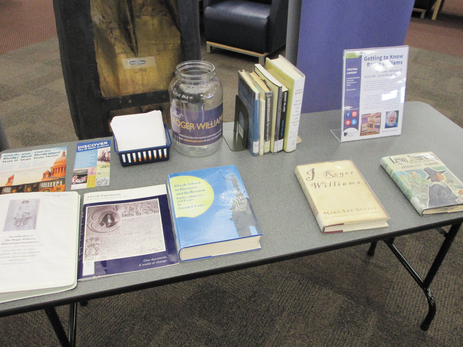 WEALTH OF MATERIALS: The “Roving Roger” exhibit, current at the Cranston Public Library, includes a host of books and other educational materials related to Rhode Island’s founder.